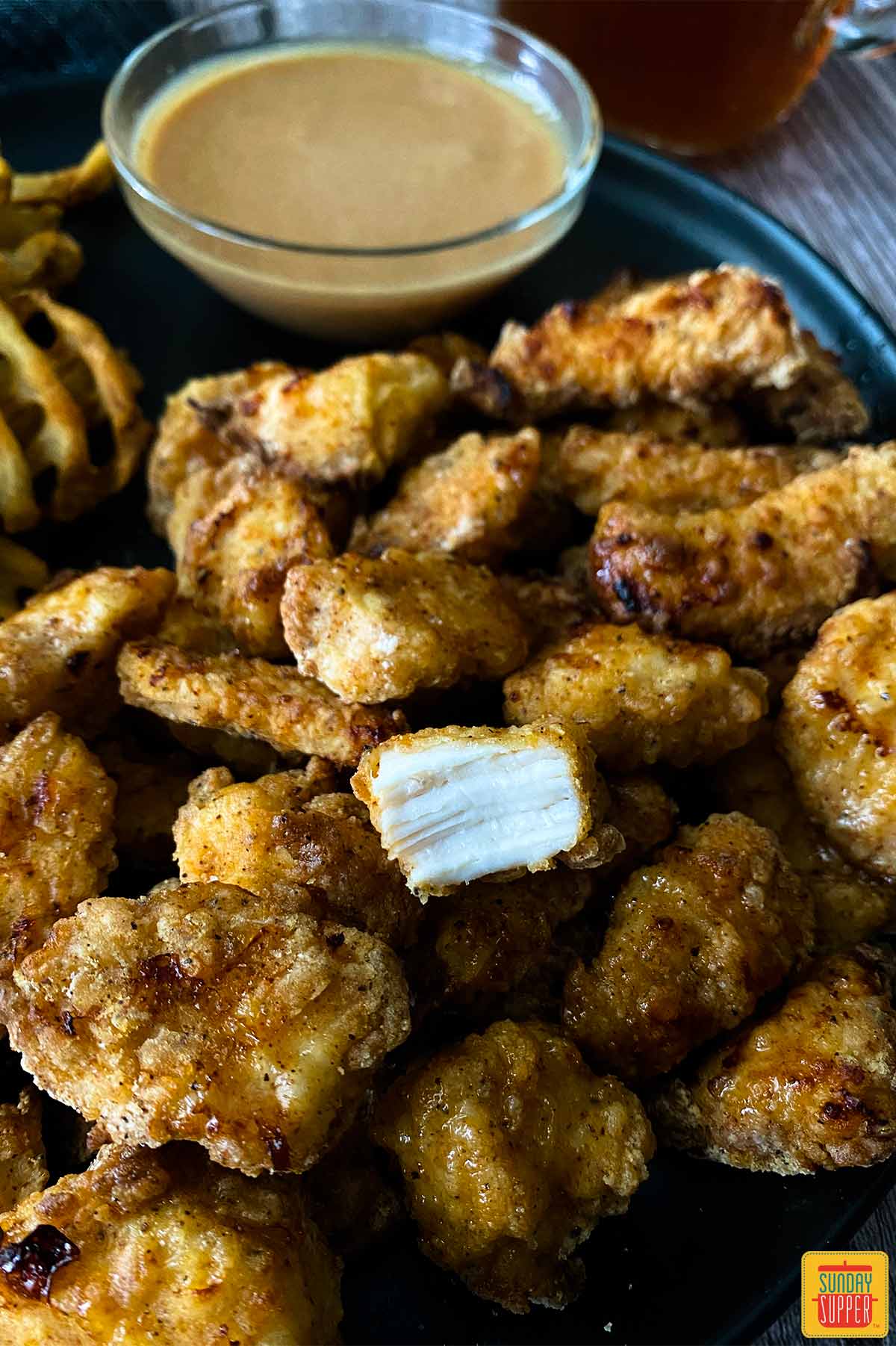 Air fryer chick-fil-a nuggets, once with a bite taken out of it