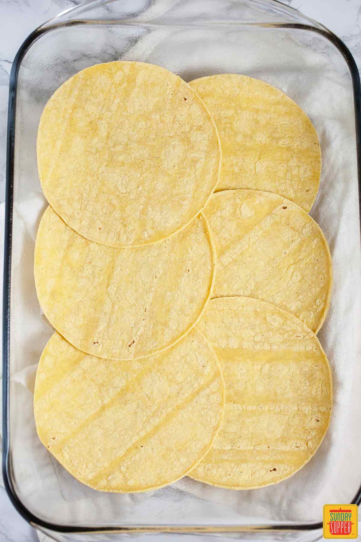 Tortillas in a baking dish.