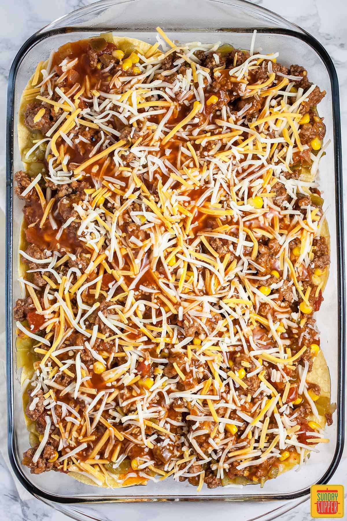 Ground beef and cheese in a baking dish.