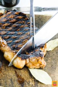 Slicing steak on a cutting board