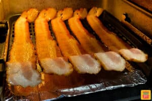 Strips of bacon on the air fryer tray