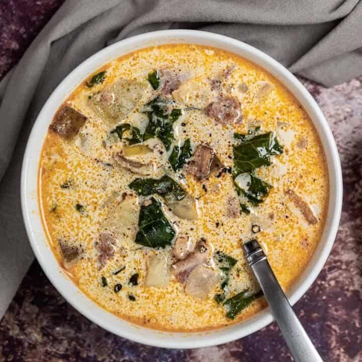 A bowl of instant pot zuppa toscana with a spoon