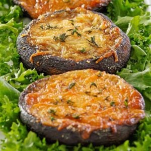 up close baked portobello mushrooms surrounded by lettuce