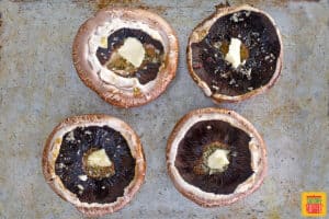 Portobello mushrooms with butter ready to bake
