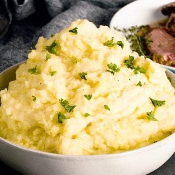 creamy mashed potatoes piled high in a white dish