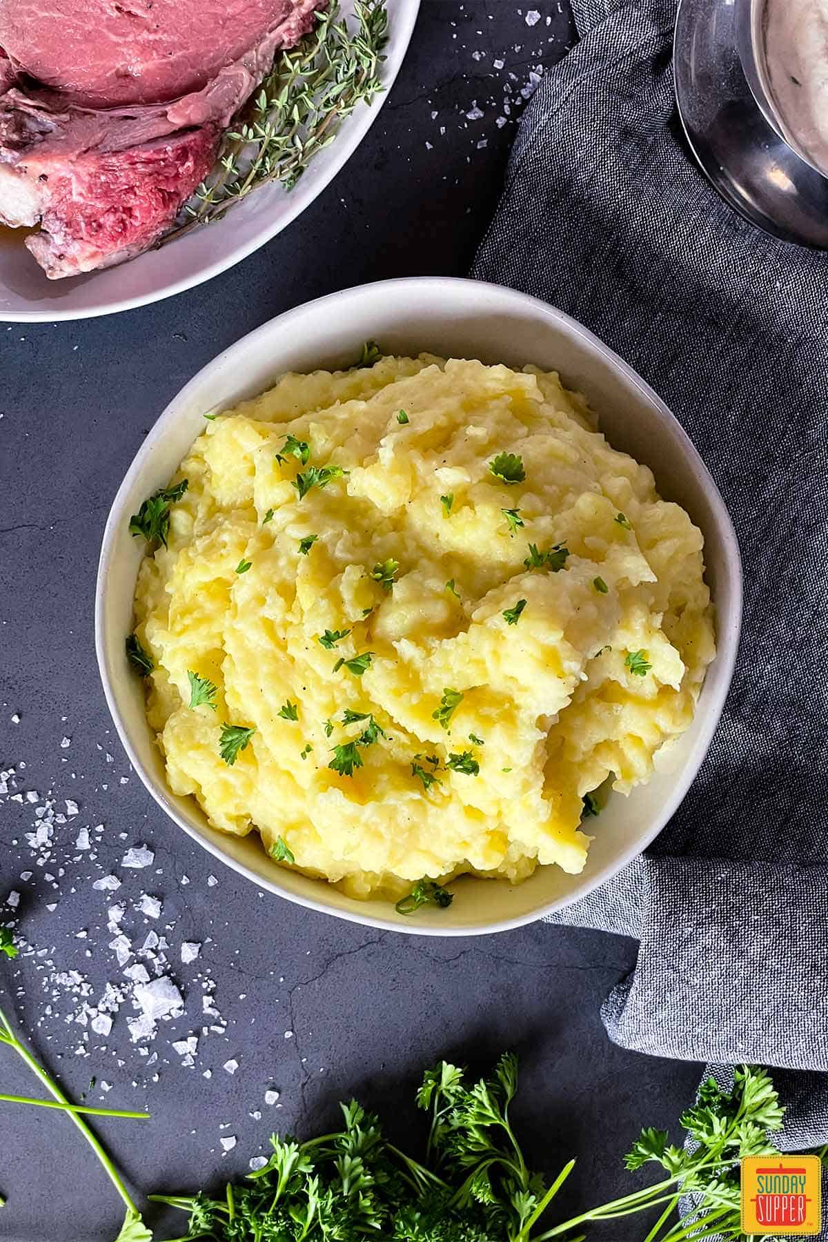 Mashed potatoes with chives in a white bowl