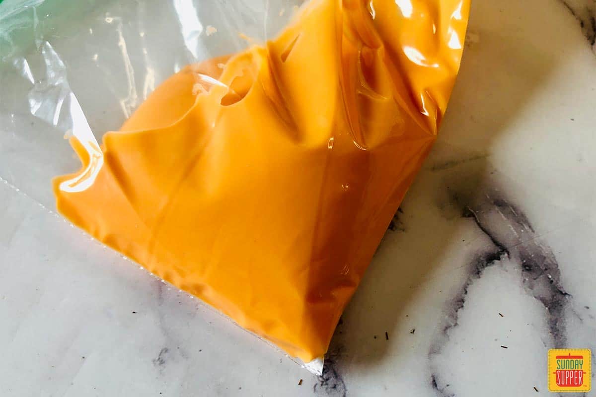 Orange white chocolate in a bag for piping