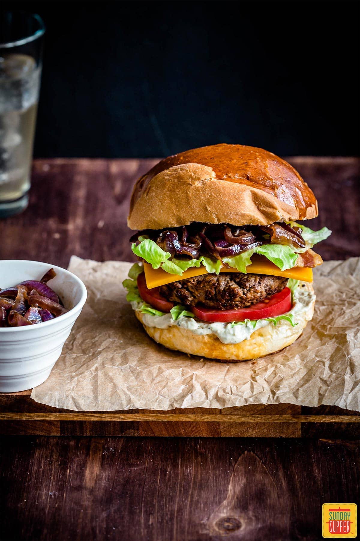 loaded burger on a parchment sheet