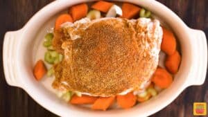 Turkey breast and carrots in a roasting pan