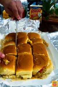 Slicing Hawaiian roll sliders into individual sandwiches