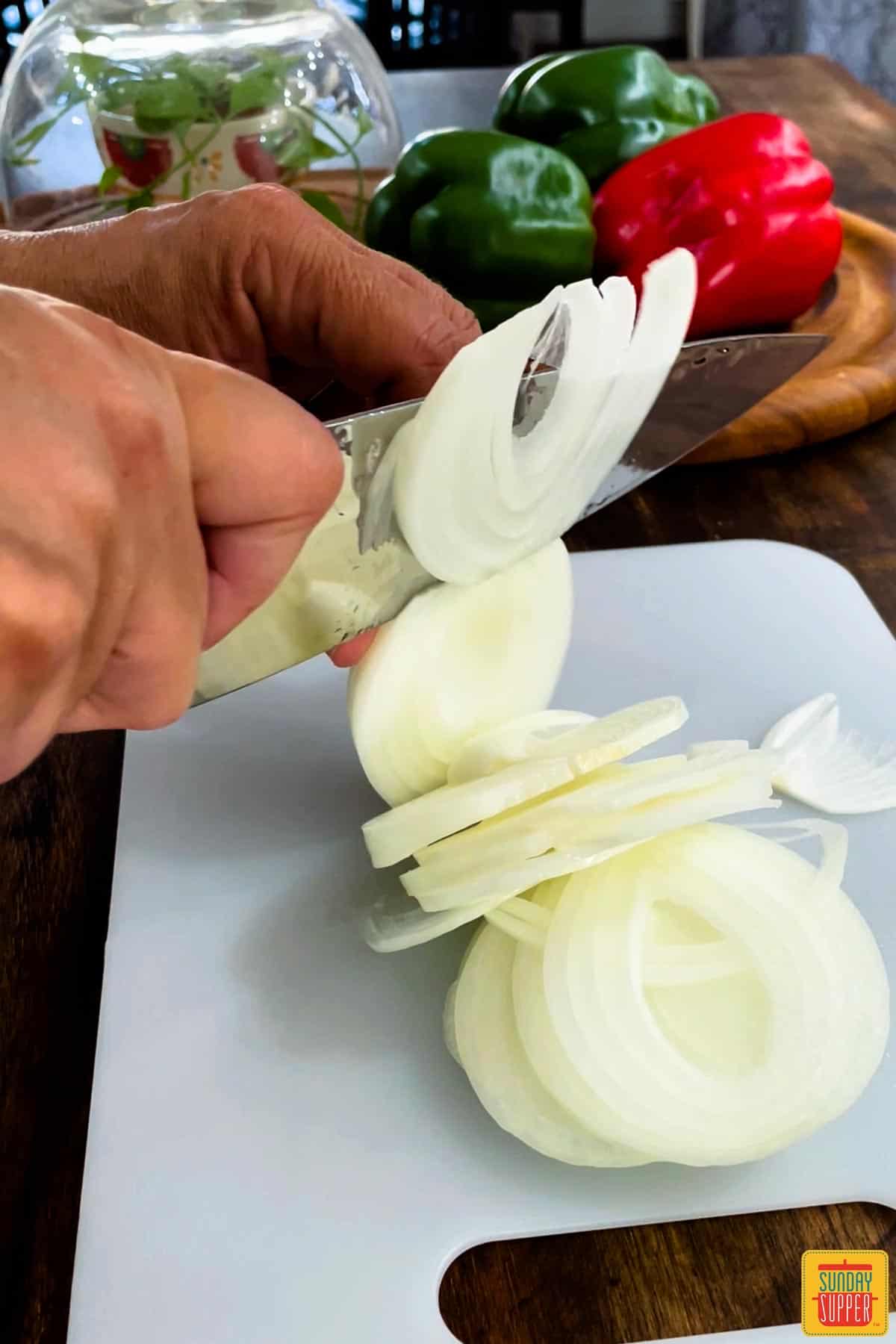 Onions cut into slices on a cutting board