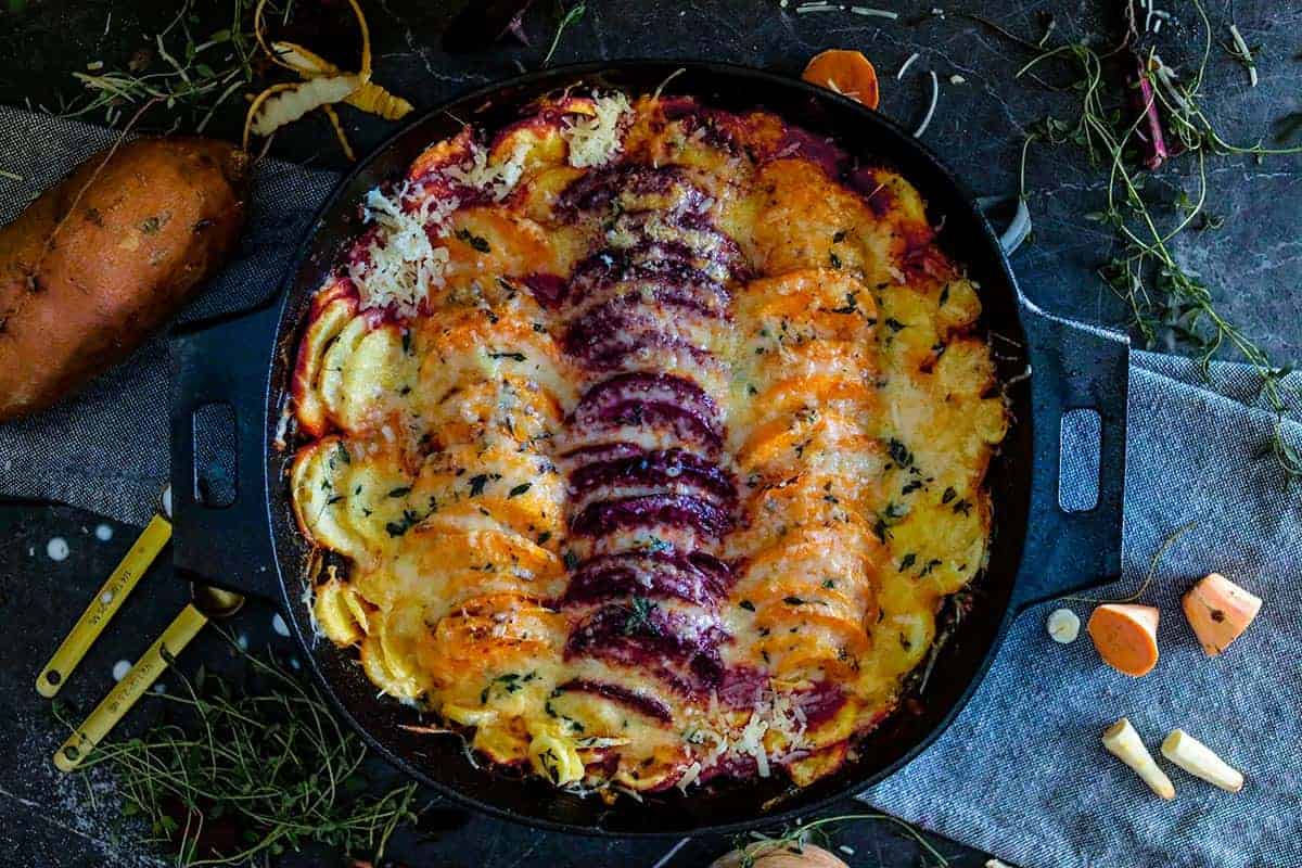 vegetable au gratin in a black skillet