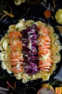 Au gratin vegetables arranged in a cast iron skillet by color