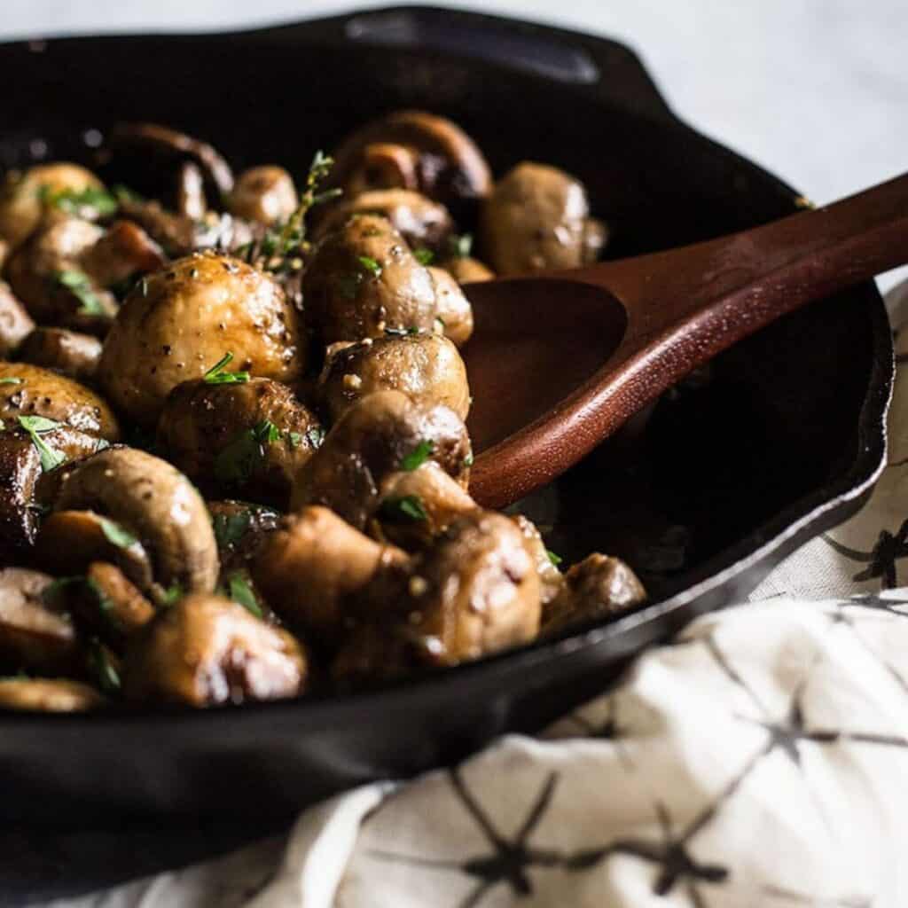 button mushrooms in a saute pan