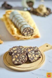 chocolate salami sliced on a round wooden board