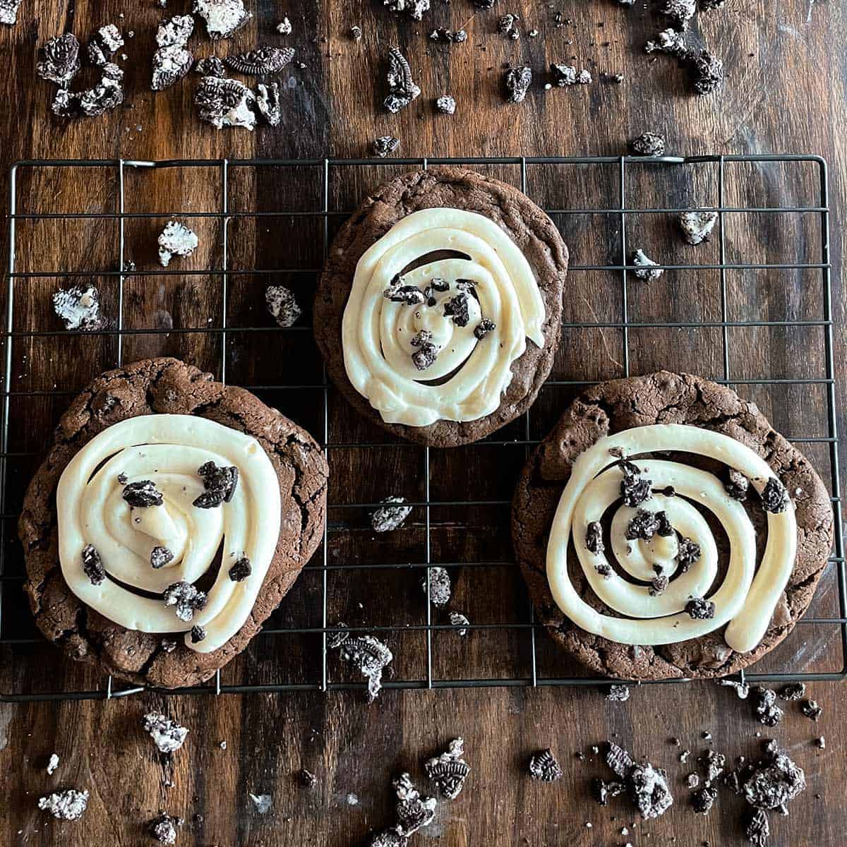 three crumbl cookies on a baking rack