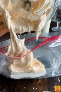 Adding cream cheese frosting to piping bag