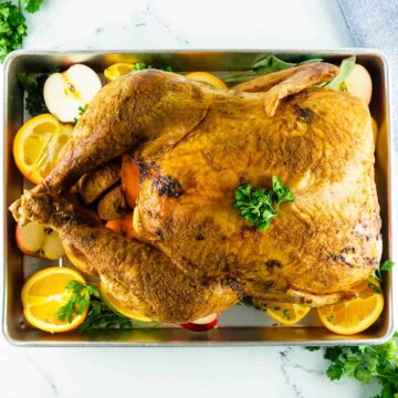 whole smoked turkey on a tray with citrus