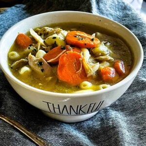 Turkey carcass soup in a bowl that says thankful