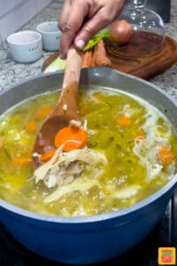 stirring turkey noodle soup