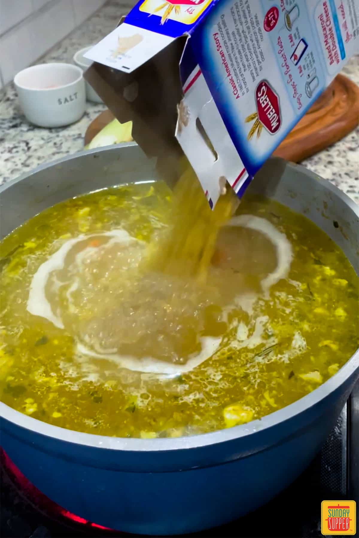 Adding noodles to turkey carcass soup