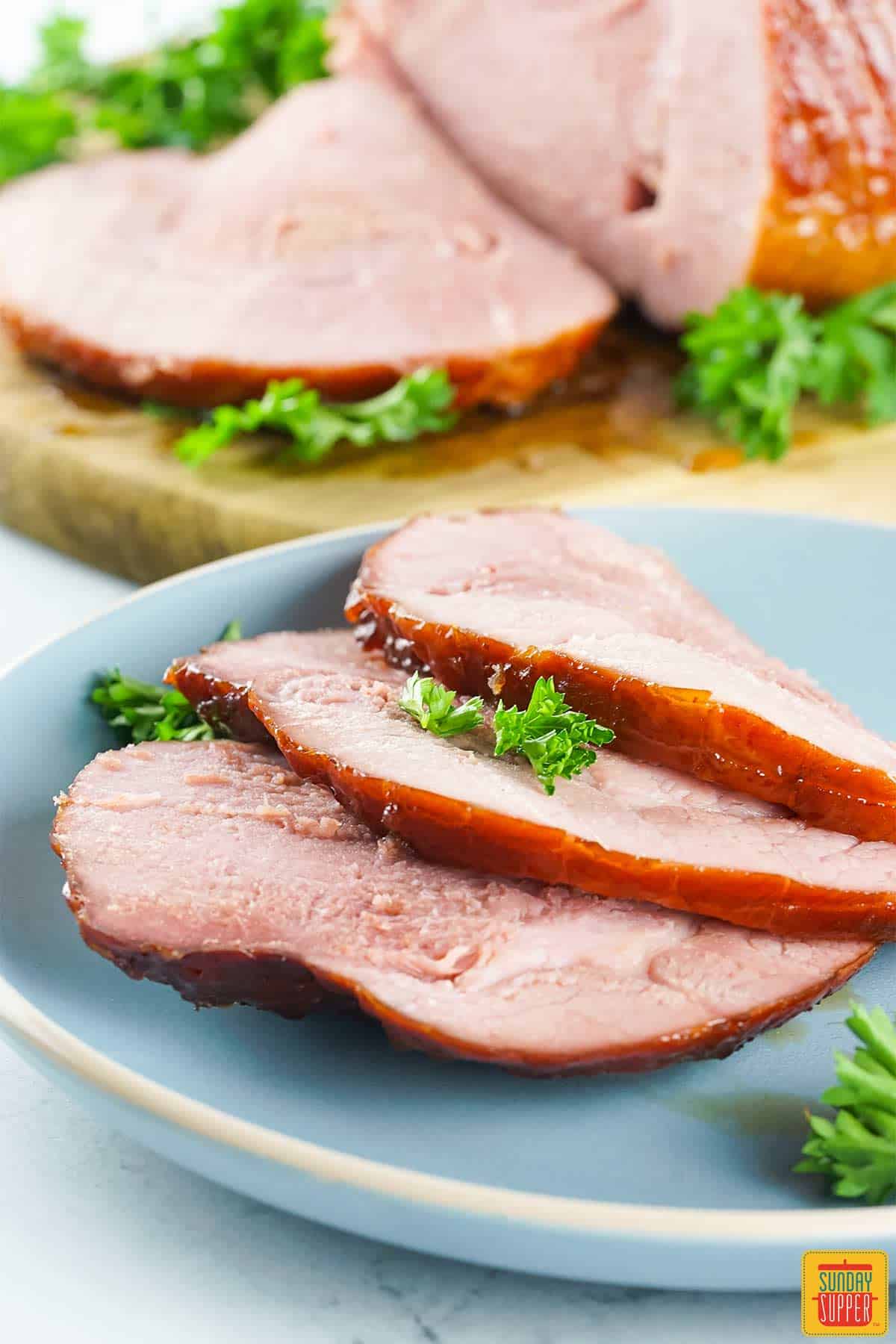 slices of smoked ham on a blue plate