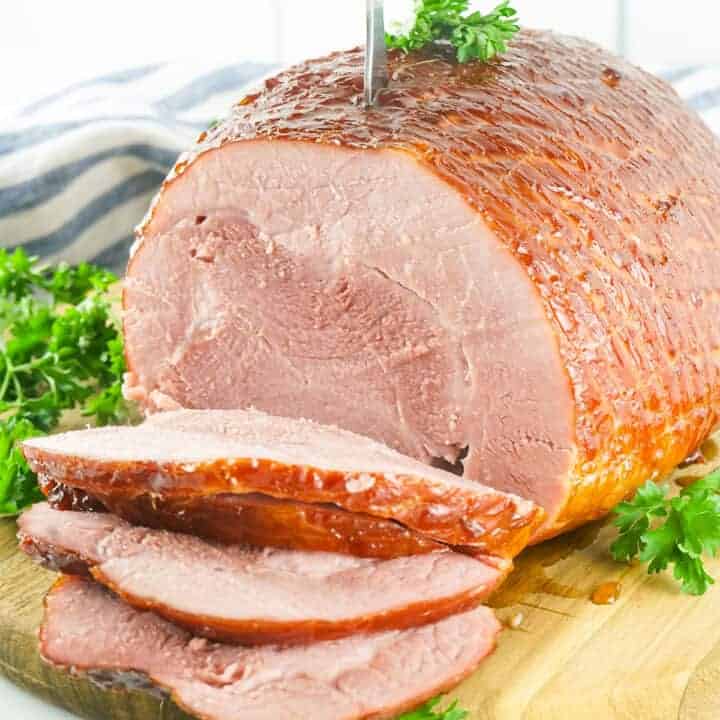 smoked ham on a cutting board sliced