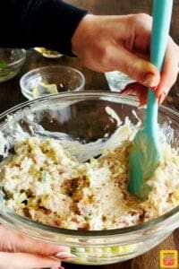 Mixing ham salad in a bowl with mayo and other ingredients