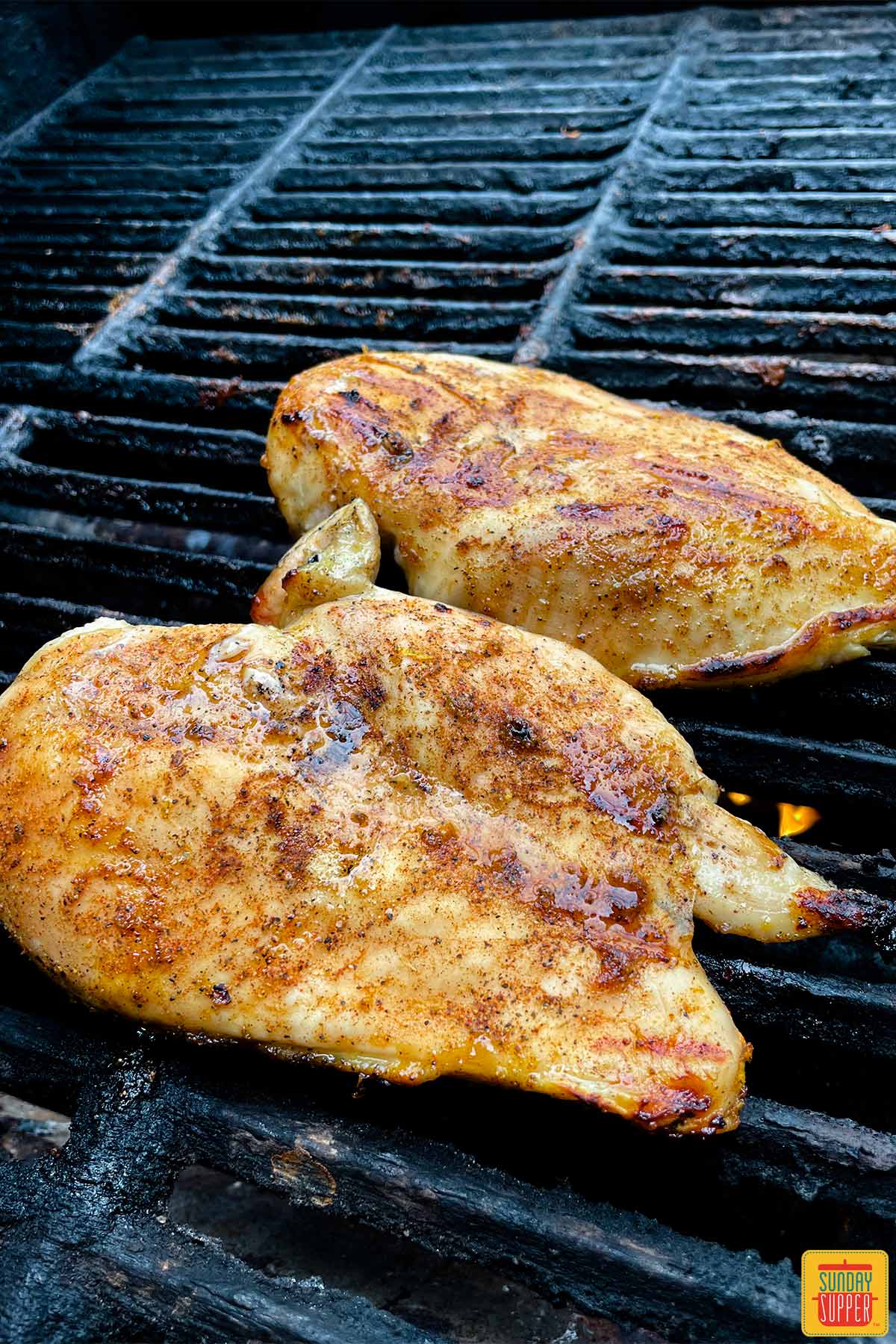 flipped chicken breasts on the grill