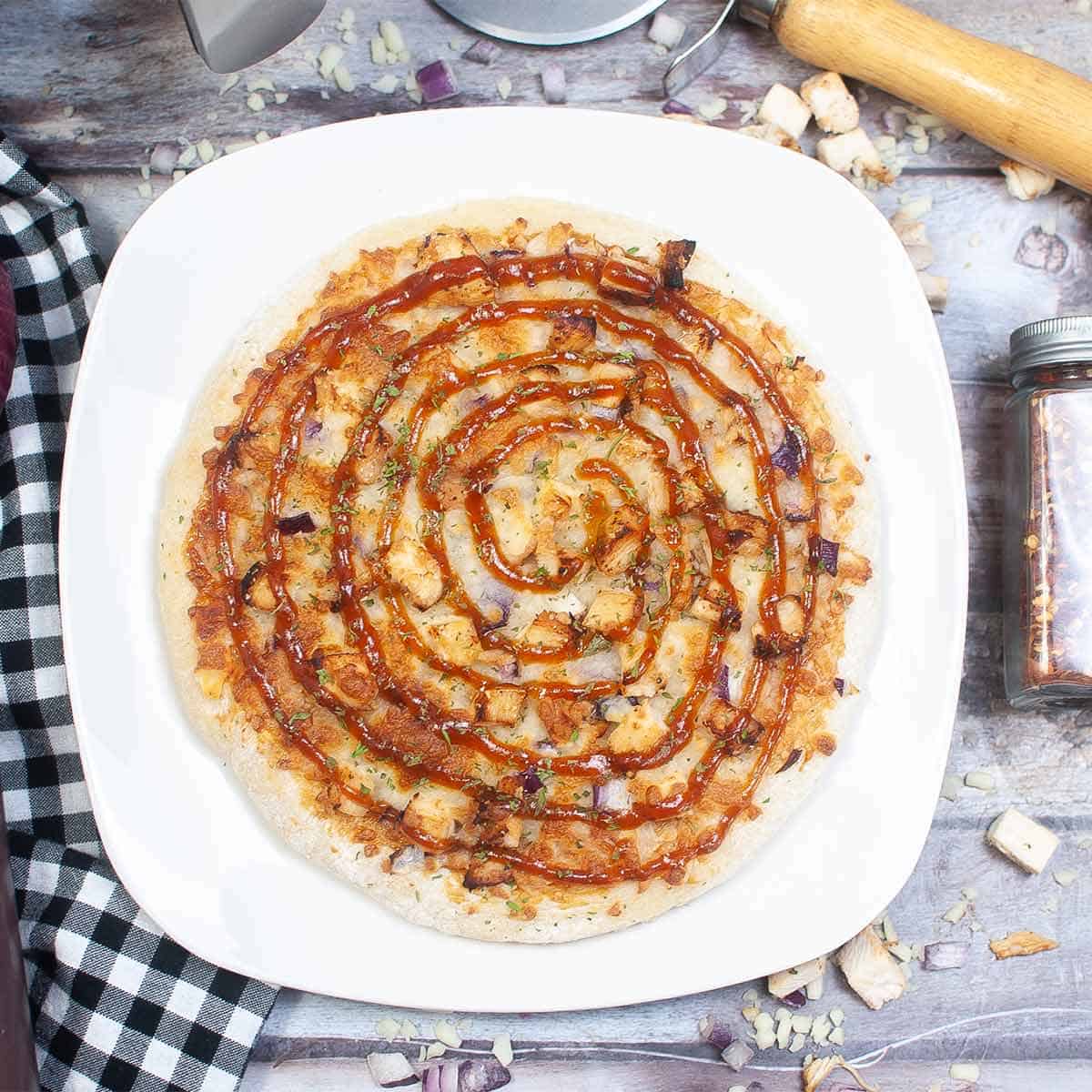 bbq chicken pizza on a white plate