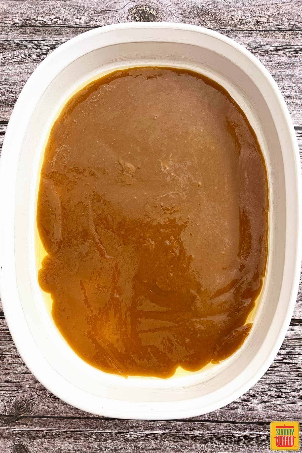 caramel spread at the bottom of a baking pan