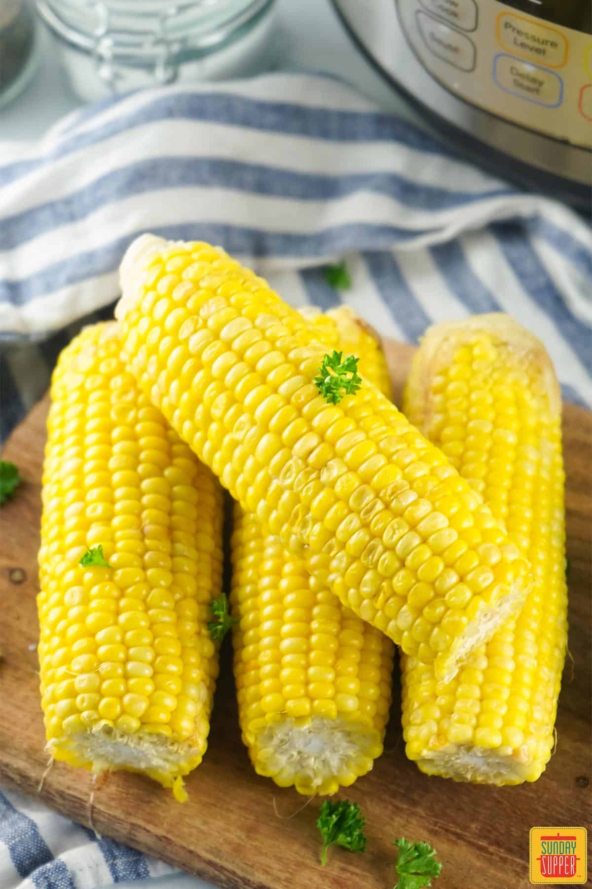 Corn on the cob on a wooden cutting board