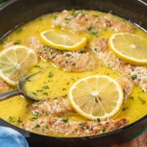 lemon butter chicken tenders cooking in pan with sauce