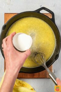 adding heavy cream to lemon butter sauce