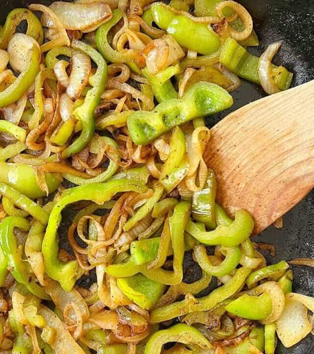 sauteed peppers and onions browned in a skillet