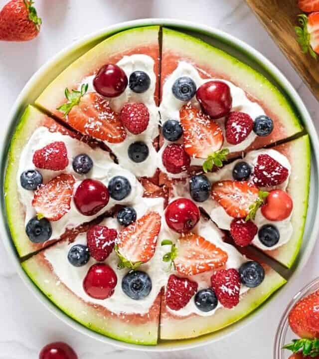 a full watermelon pizza on a white surface