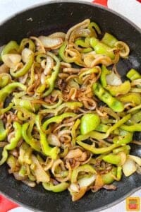 peppers and onions in a cast iron skillet