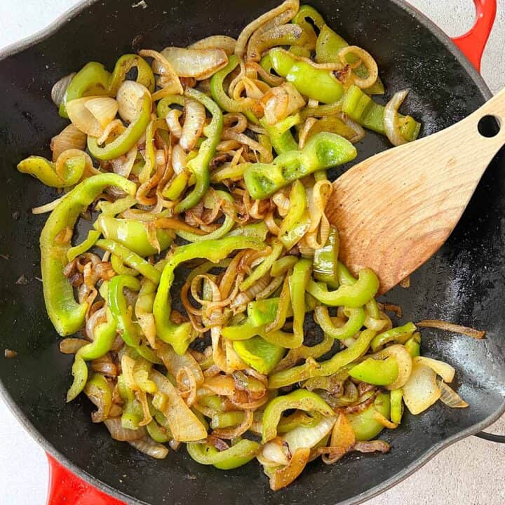 sauteed peppers and onions browned in a skillet