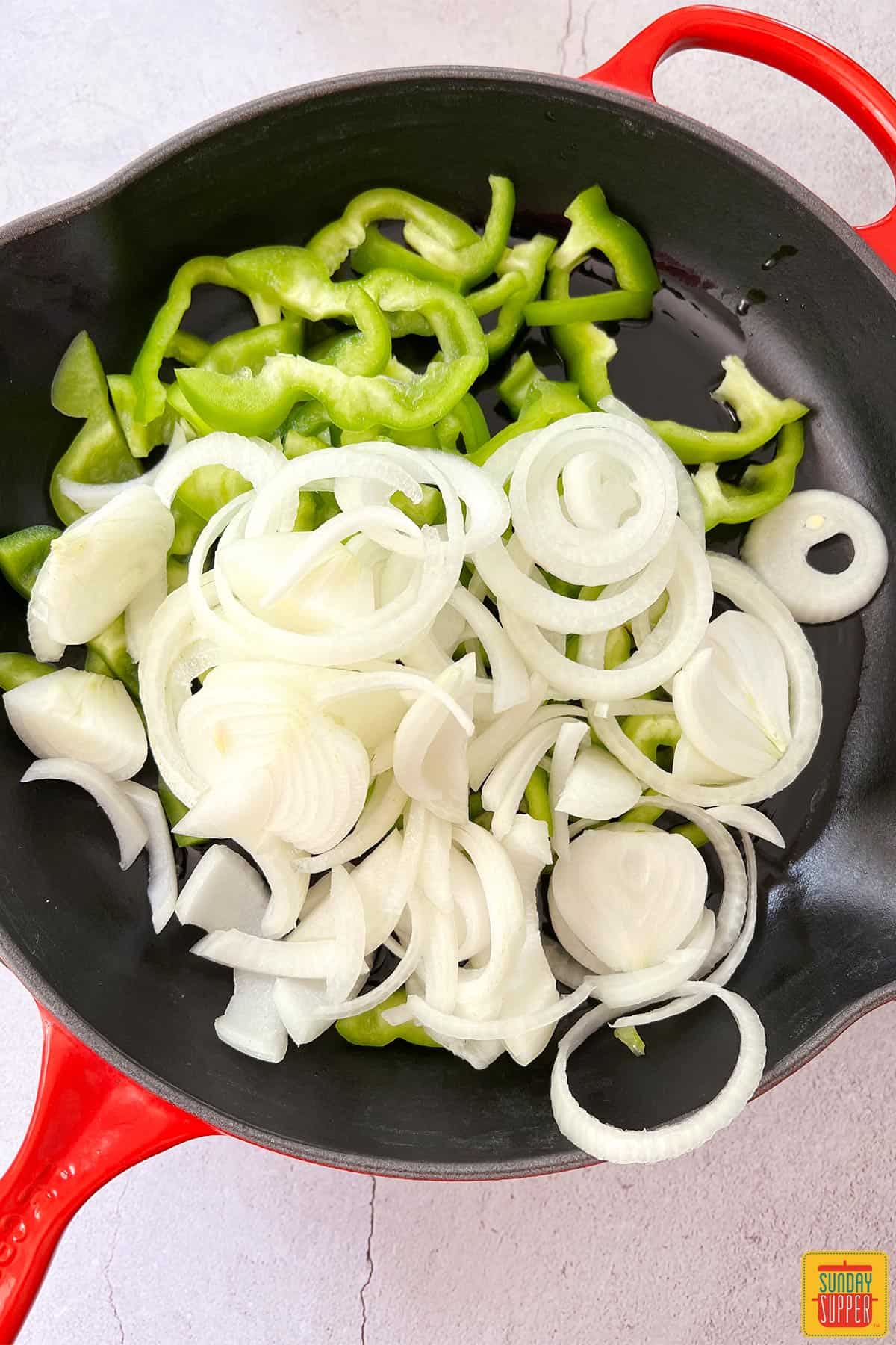 peppers and onions placed in skillet