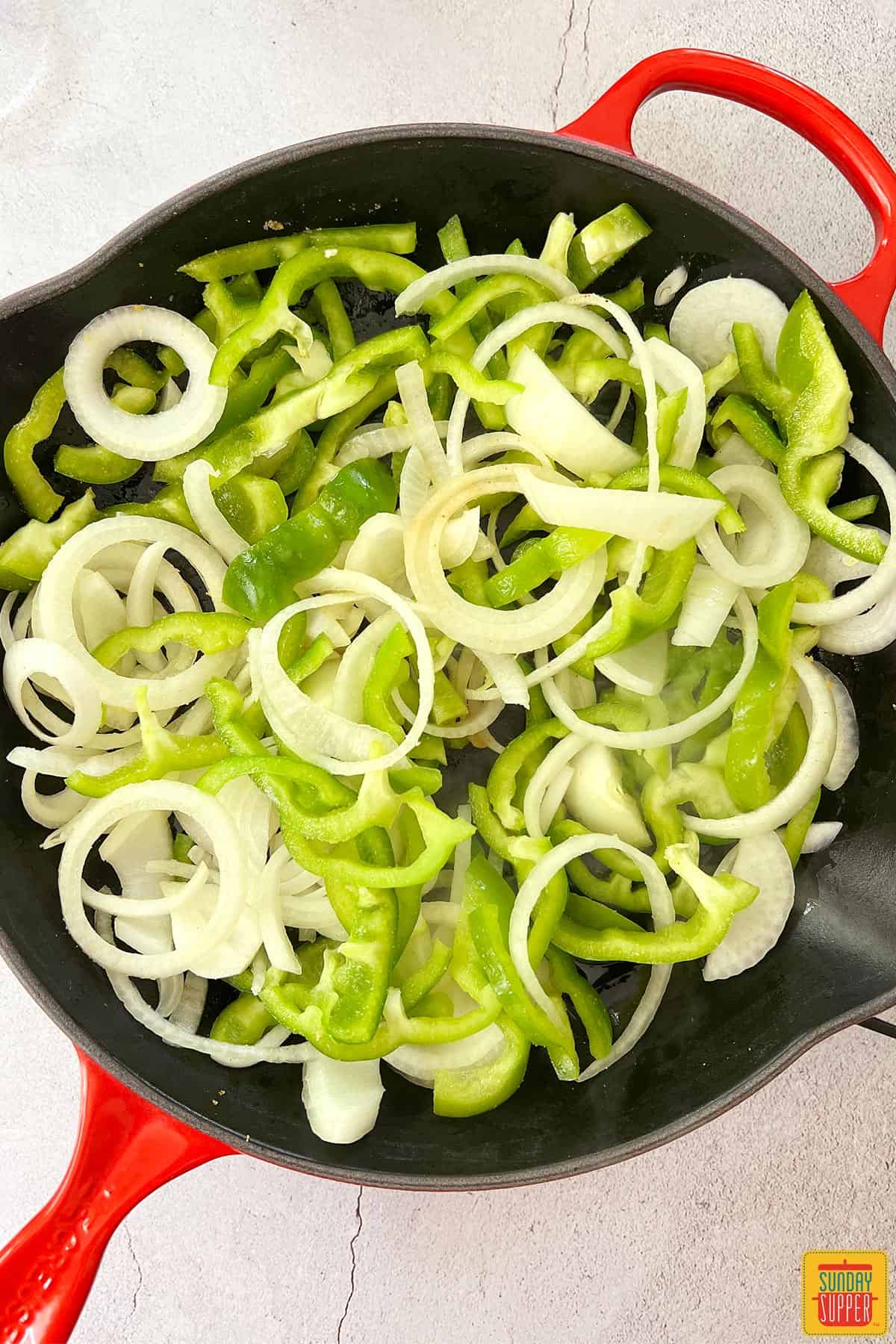 seasoned peppers and onions in skillet