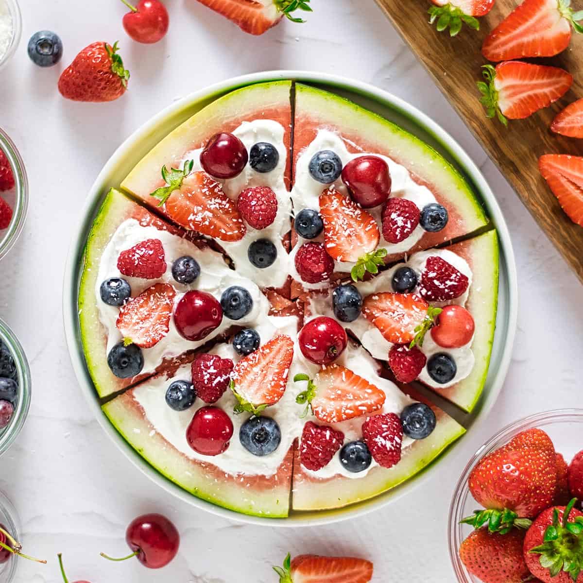 a full watermelon pizza on a white surface