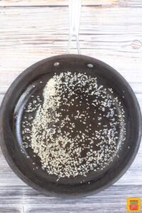 toasting sesame seeds in a pan
