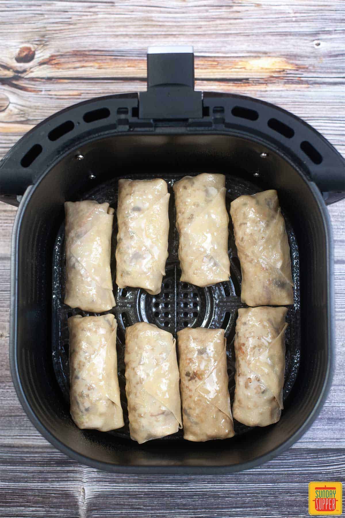 egg rolls stacked in an air fryer