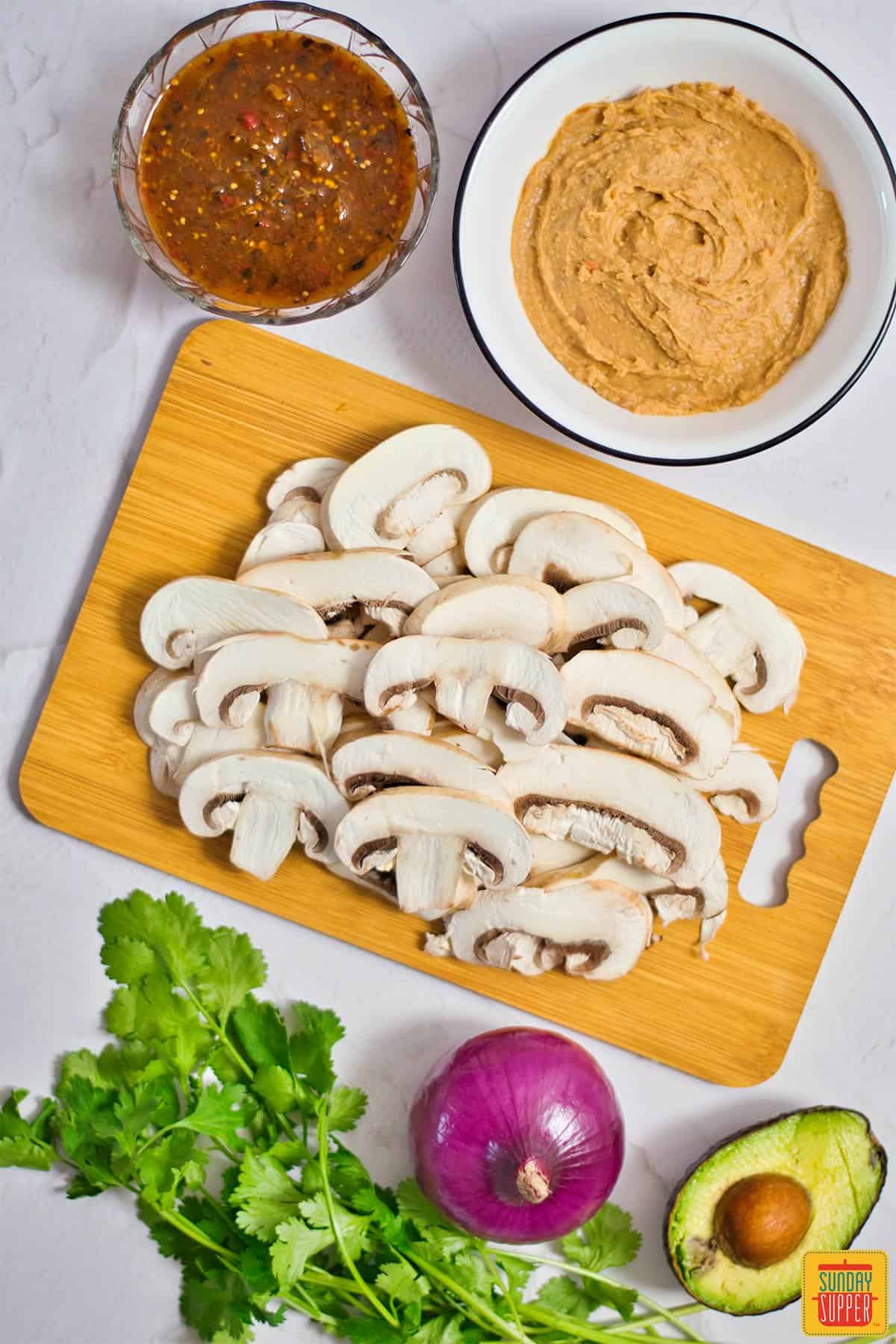 mushrooms for vegetable tacos on a cutting board