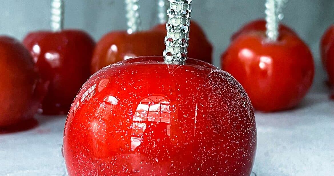 red candied apples on a white surface