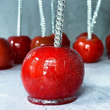 red candied apples on a white surface