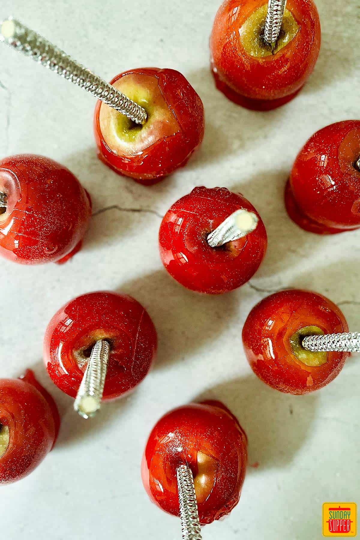 red candied apples on a grey background