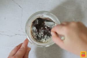 mixing flour and baking powder into mug brownie recipe