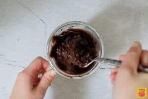 folding chocolate chips into mug brownie recipe