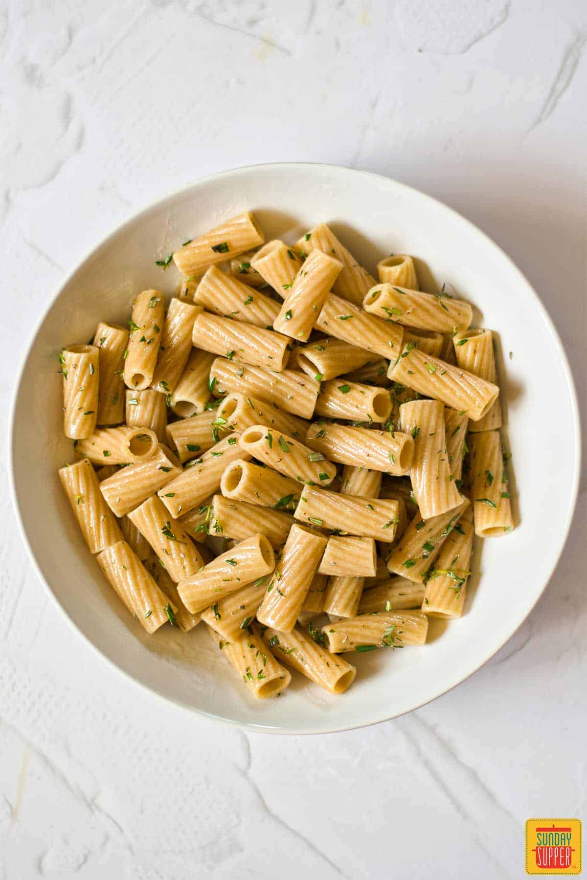 pasta in a bowl with herbs